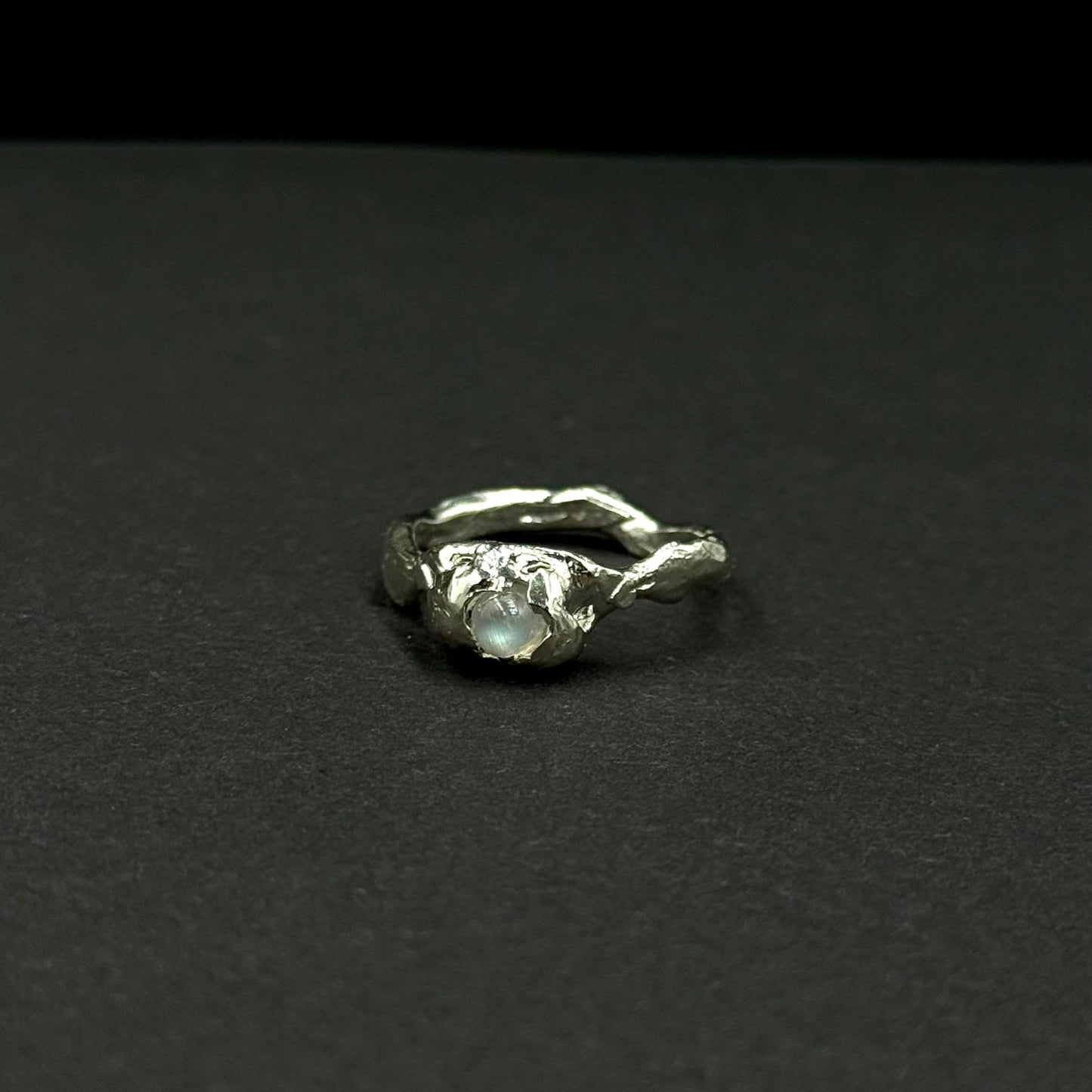 Sterling silver ring with a natural moonstone in an organic textured setting