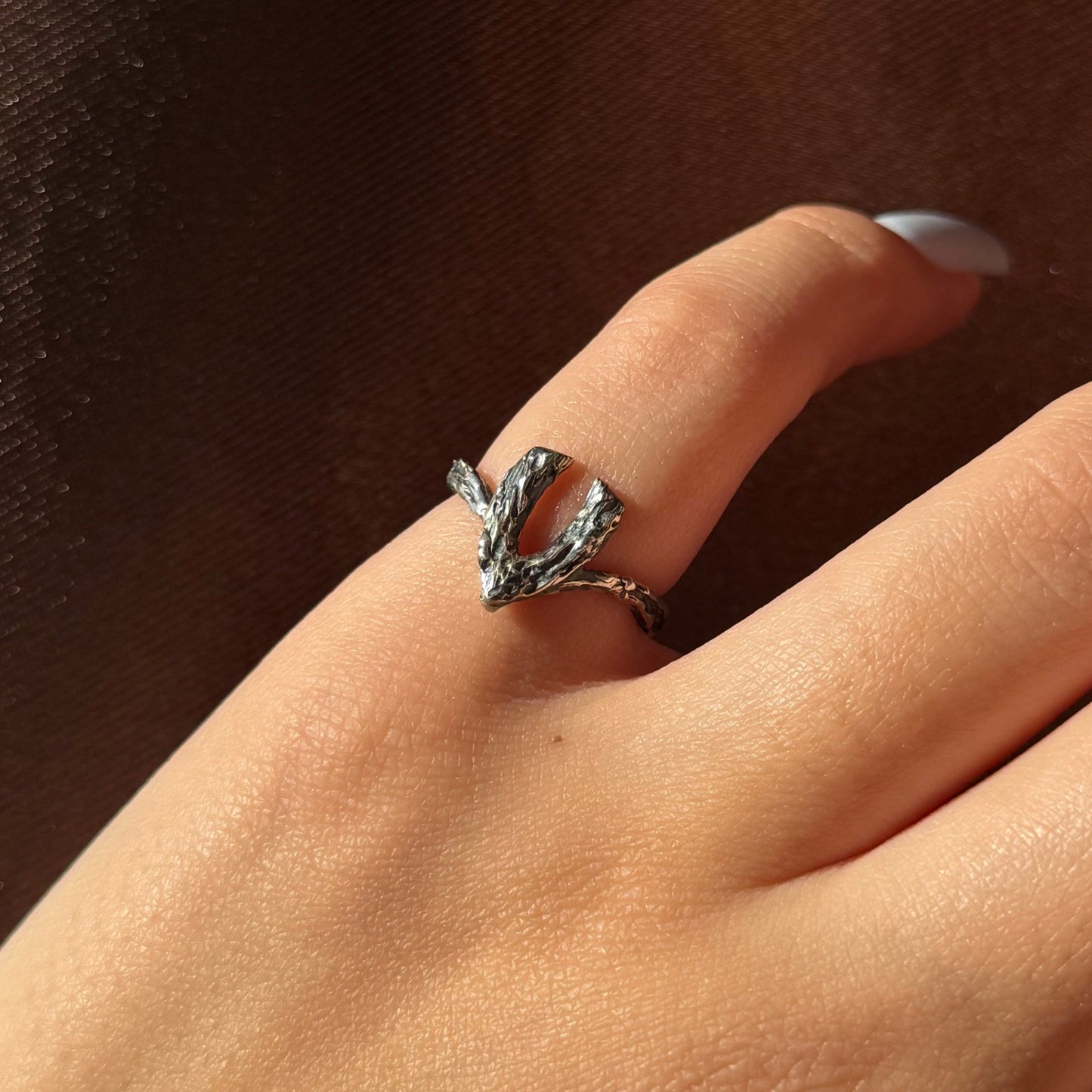 Handmade silver ring with a textured, V-shaped design