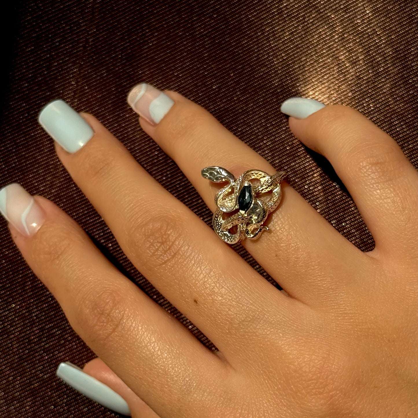 Handmade silver snake ring with intricate detail. Choose amethyst, sapphire, or emerald — each stone carries its own meaning. Crafted with care to last a lifetime