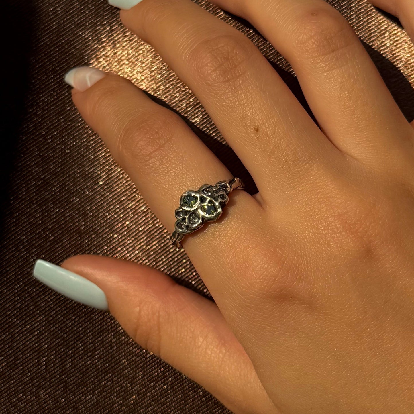 Sterling silver ring with cubic zirconia, featuring a delicate floral-inspired design