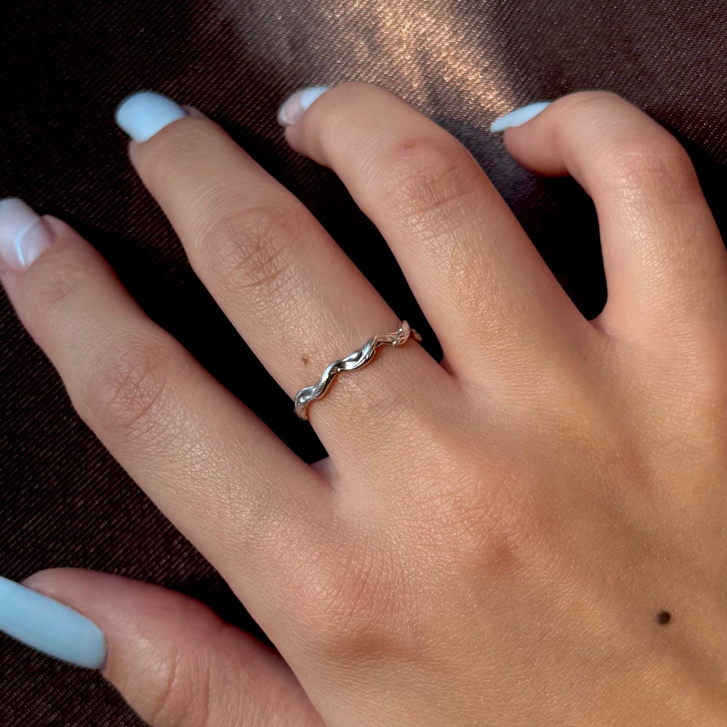 Sterling silver adjustable ring with a textured, organic design