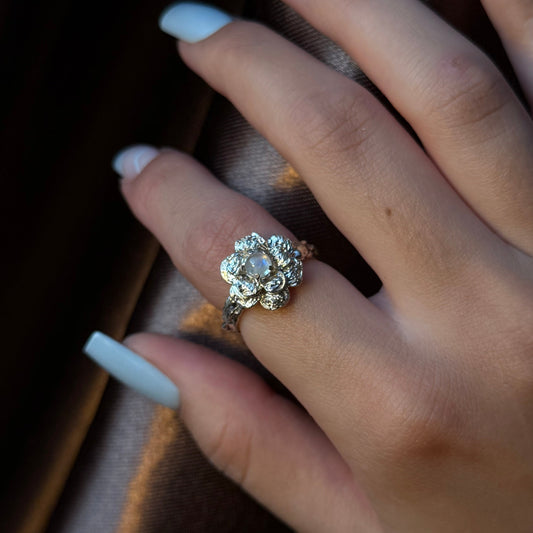 Sterling silver flower ring with a natural moonstone centerpiece