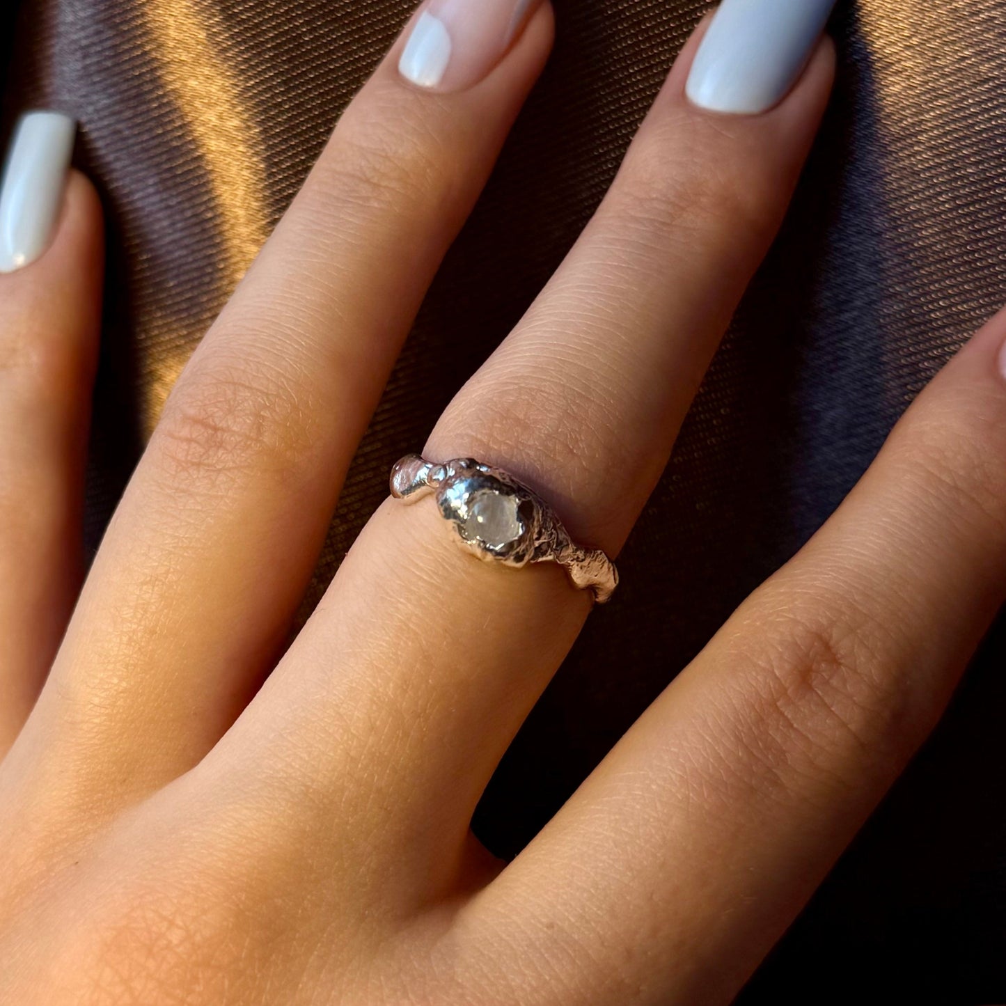 Sterling silver ring with a natural moonstone in an organic textured setting