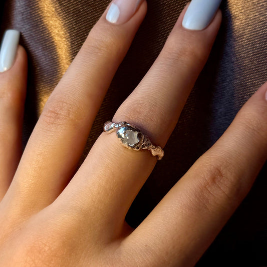 Sterling silver ring with a natural moonstone in an organic textured setting