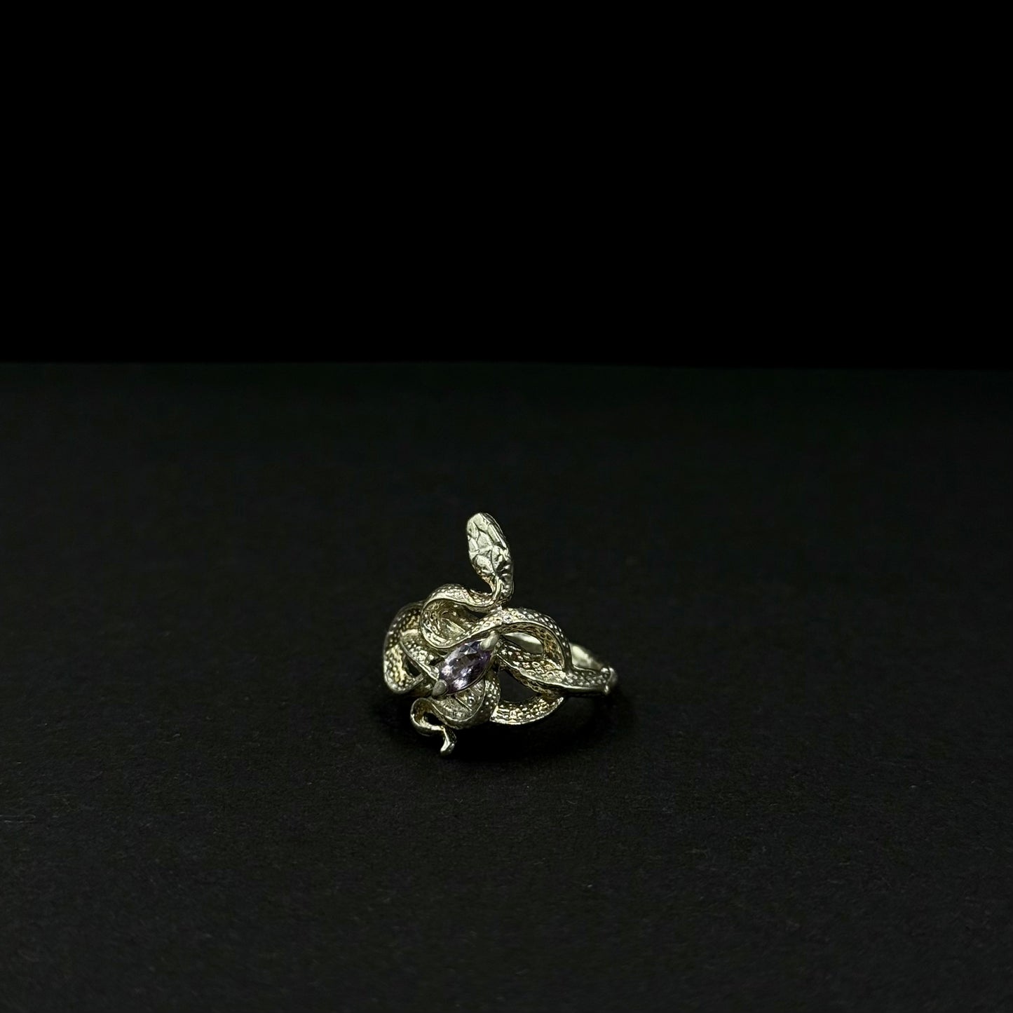 Handmade silver snake ring with intricate detail. Choose amethyst, sapphire, or emerald — each stone carries its own meaning. Crafted with care to last a lifetime