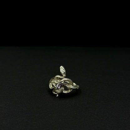 Handmade silver snake ring with intricate detail. Choose amethyst, sapphire, or emerald — each stone carries its own meaning. Crafted with care to last a lifetime