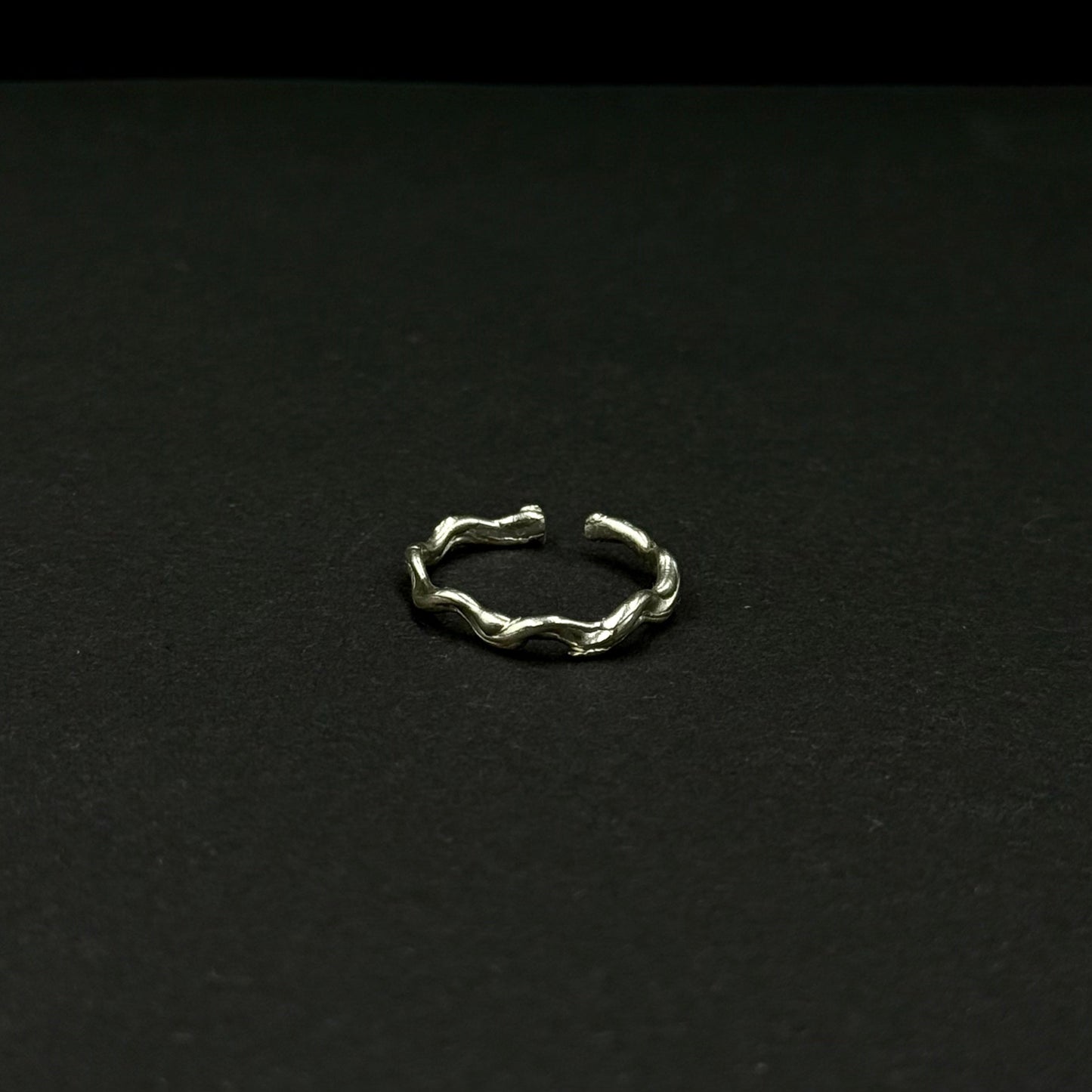 Sterling silver adjustable ring with a textured, organic design