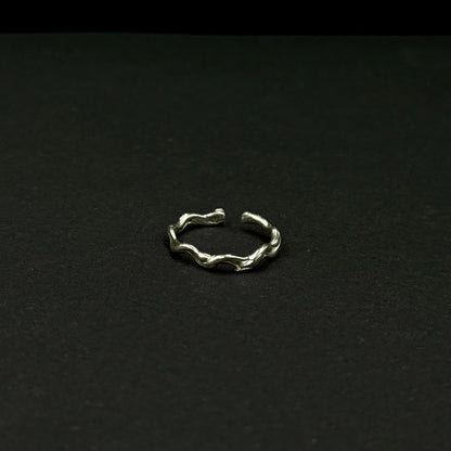Sterling silver adjustable ring with a textured, organic design