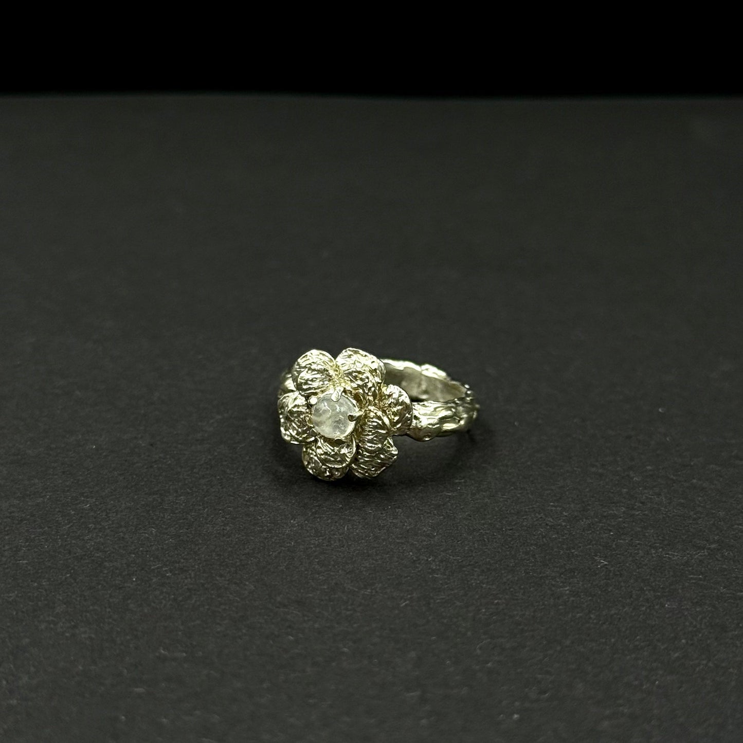 Sterling silver flower ring with a natural moonstone centerpiece