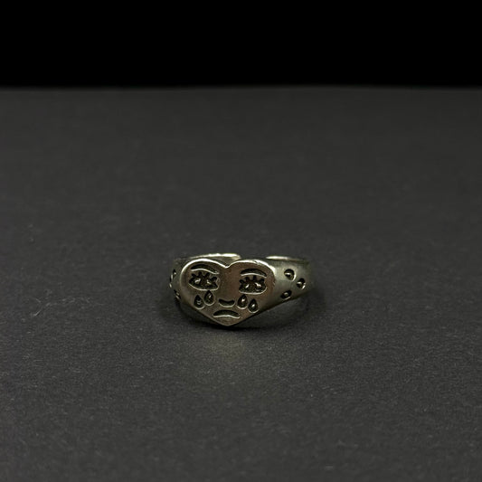 Adjustable silver ring with a heart design and engraved expressive face