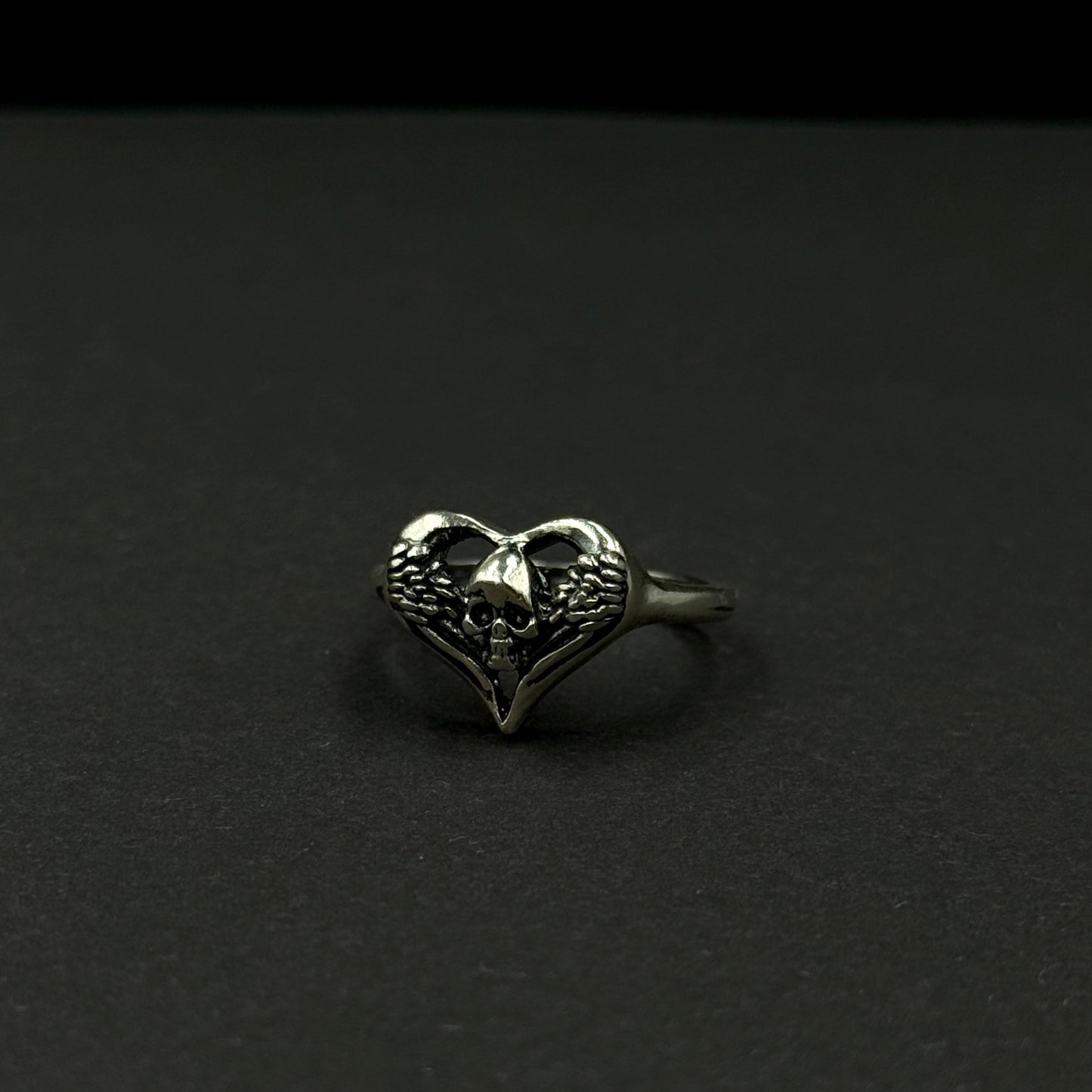 Handmade silver ring with heart-and-skull design