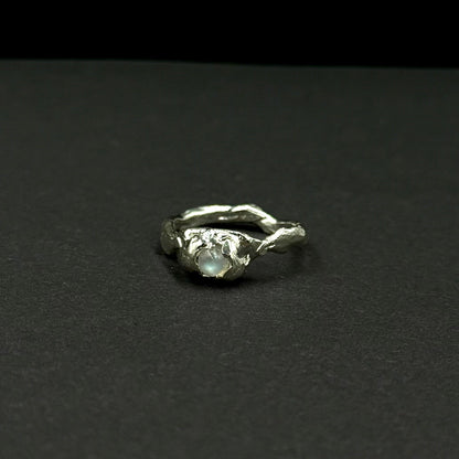 Sterling silver ring with a natural moonstone in an organic textured setting
