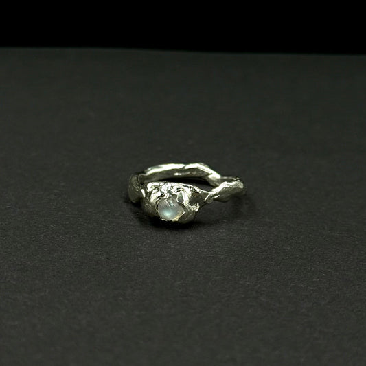 Sterling silver ring with a natural moonstone in an organic textured setting