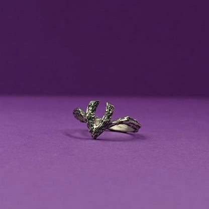 Handmade silver ring with a textured, V-shaped design