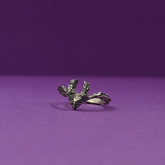 Handmade silver ring with a textured, V-shaped design